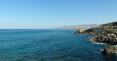 Fototapeta na wymiar rocky shore of the blue sea, waves, sky, top view