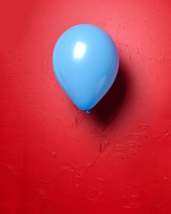 Blue latex balloon object for birthday or valentines day party on red