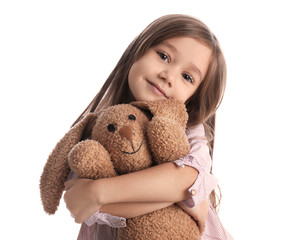 Portrait of cute little girl with toy bunny on white background