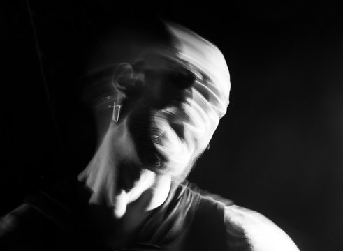 Portrait of a  man screaming in soft focus and long exposure