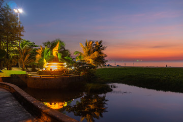 Fototapeta premium sunset behind golden dragon statue on Karon beach Phuket Thailand