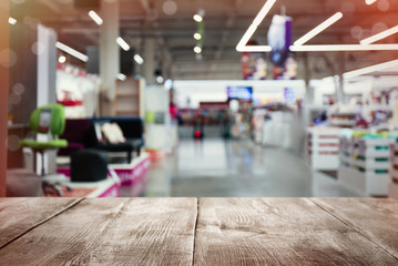 Empty wooden surface and blurred view of furniture store in mall. Space for design