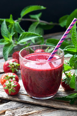 Strawberry  smoothie in glass with cocktail straw