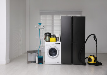 Refrigerator and different household appliances in room