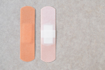 Two medical patches on neutral background. First aid concept. The textile sticky patch.