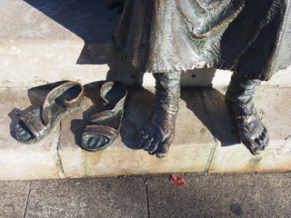 Closeup of foot of statue of a pilgrim, Camino de Santiago, Way of St. James, Journey from Mansilla de las Mulas to Leon, French way, Spain © Mithrax