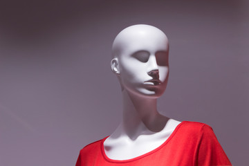 Mannequin head. Red T-shirt, discounts, white, gray background.
