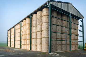 An open sided barn full of straw