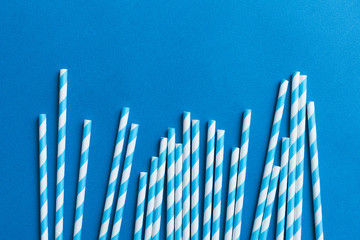 Blue straws for cocktails on a blue background