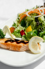 organic mixed vegetable salad with salmon fillet and balsamic vinaigrette