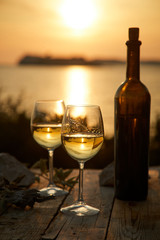 two glasses with wine during sunset time