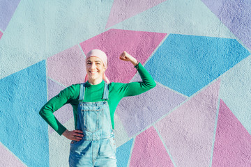 Portrait of woman with pink headscarf, has cancer. Show the arm as a signal of strength