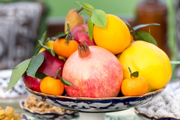Fresh fruits plate at the table, healthy eating concept