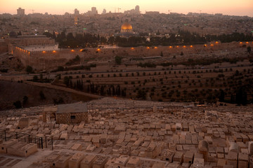 Fototapeta na wymiar JERUSALEM, ISRAEL - January 2020: The outllok over the jewish cemetery on the Mount of Olives with the Dormition abbey and mosque Al axa in the backgound