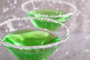 Two glasses with green drinks
