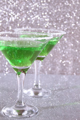Two glasses with green drinks