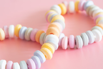 Obraz premium sweets Beads and bracelets candy on a pink background