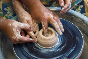 A master of pottery craftsmanship teaches a woman who wants to learn how to sculpt a jug. Pottery master class.