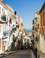 Portugal, Lisbon in summer, local color of narrow old street in Lisbon, street facing to the river Tagus Lisbon