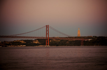 Portugal, Lisbon, evening landscape of Tagus river Lisbon, Ponte April 25th bridge over Tagus river, Lisbon on the Tagus river bank, Christ The King Statue over Lisbon