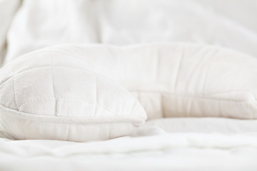 White ergonomic pillow in bed. Close up.