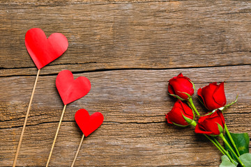 Red rose flower and gift box with copy space on wooden background. Valentine day concept 