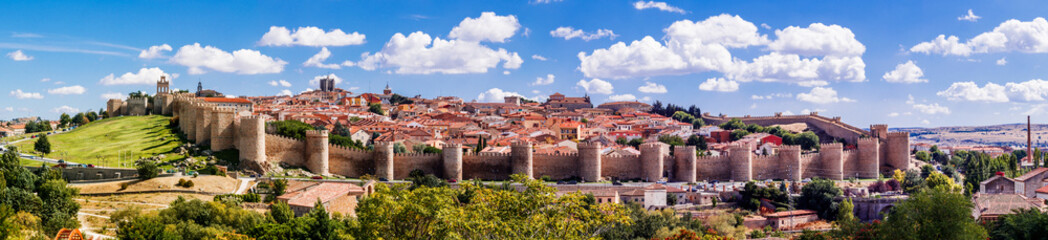 Fototapeta na wymiar Beautiful picturesque panoramic view of the historic city of Avila from the Mirador of Cuatro Postes, Spain, with its famous medieval town walls. UNESCO World Heritage.