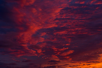 Beautiful red and blue evening sky with many clouds over the sea. Dramatic sky.