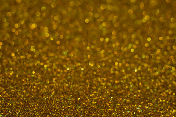 Abstract Christmast bronze bokeh background with shining defocus sparkles. Blurred glitters shimmering dust macro close up, copy space for text logo