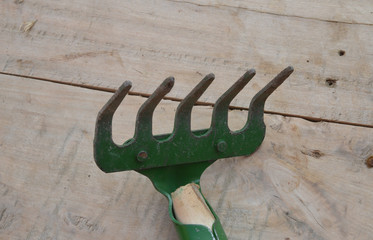 garden rake on wooden background