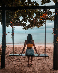 Girl playing on Swing at thailand beach in Koh Tao