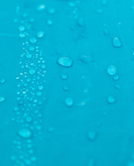 different drops of water on a blue background