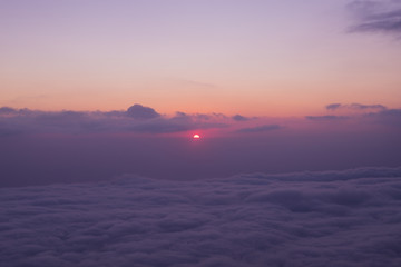 Scenic view of clouds and mist at sunrise