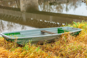 small boat on a river side on a bright sunny day