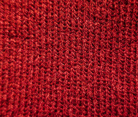 Knitted wool red seamless grainy threads texture background