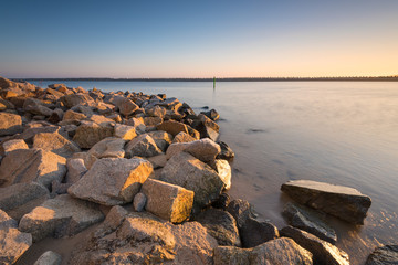 Fototapeta na wymiar Stony breakwaters on the Baltic Sea in the morning, Gdansk, Poland