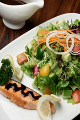 organic mixed vegetable salad with salmon fillet and balsamic vinaigrette