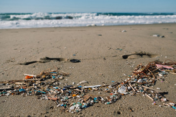 Micro plastics sea coast pollution, polluted ecosystem planet save concept