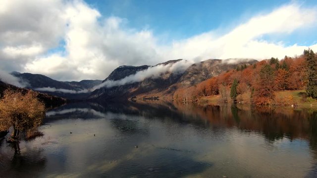 Left pan lake Bohinj with mountains covered with fog