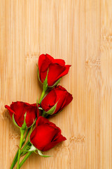 Red rose bunch on wooden board. Valentine day concept  