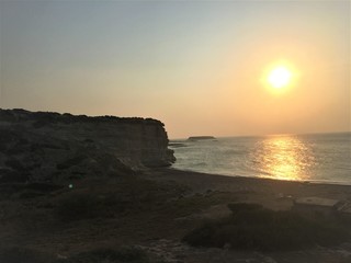 sunset on coast of sea