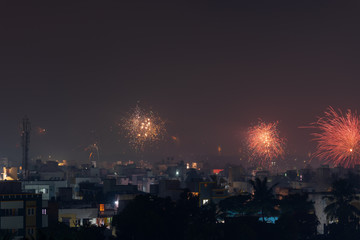 Fototapeta na wymiar Bursting fireworks during the Divali festival of light over the city of Chennai in South India