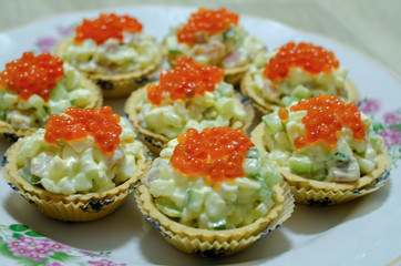 tartlets with salad and red caviar