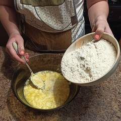 woman confectioner pour out flour to bowl