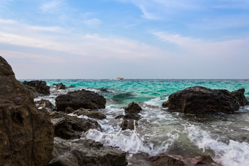 Green Sea wave Hit rocks On the Beach and Speed Boat are Floating in the Sea 02