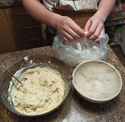 woman confectioner opening package with flour