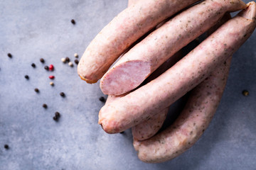 Traditional country homemade sausage on a stony background.