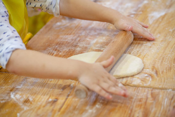 Children cooking pizza. Photo of children hands cooking Italian food. Process of cooking pizza by children in the master class. 