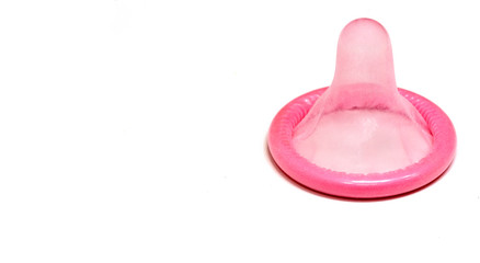 Pink condom isolated on white background