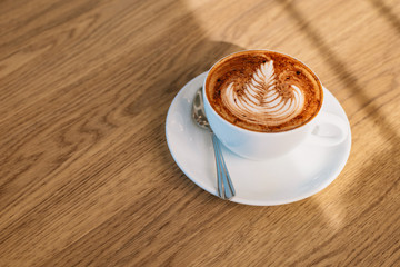 Coffee latte art on wooden table